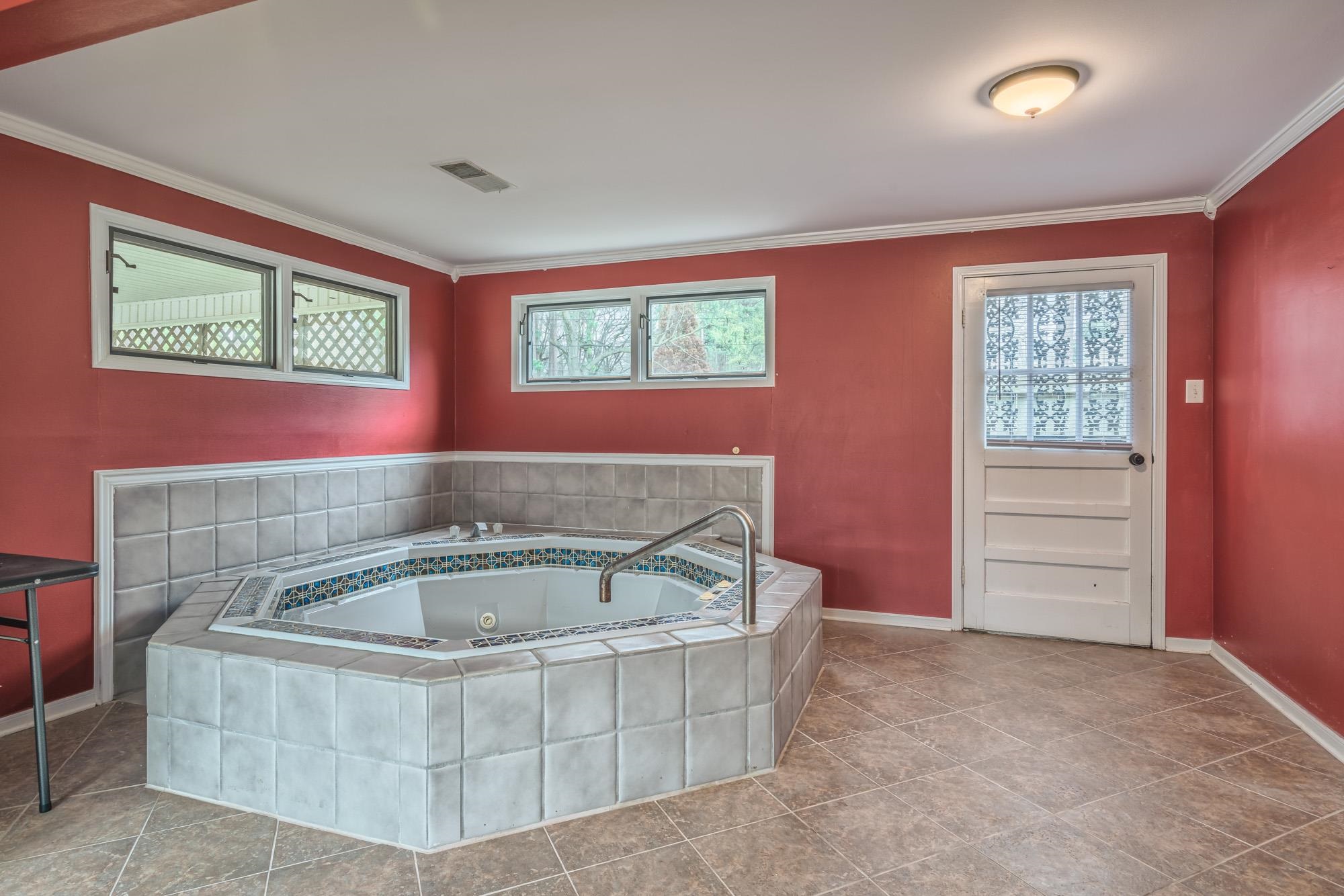 4518 Sequoia Road Memphis, TN 38117 - Photo 21 of 25 a bath tub sitting in a bathroom next to a window