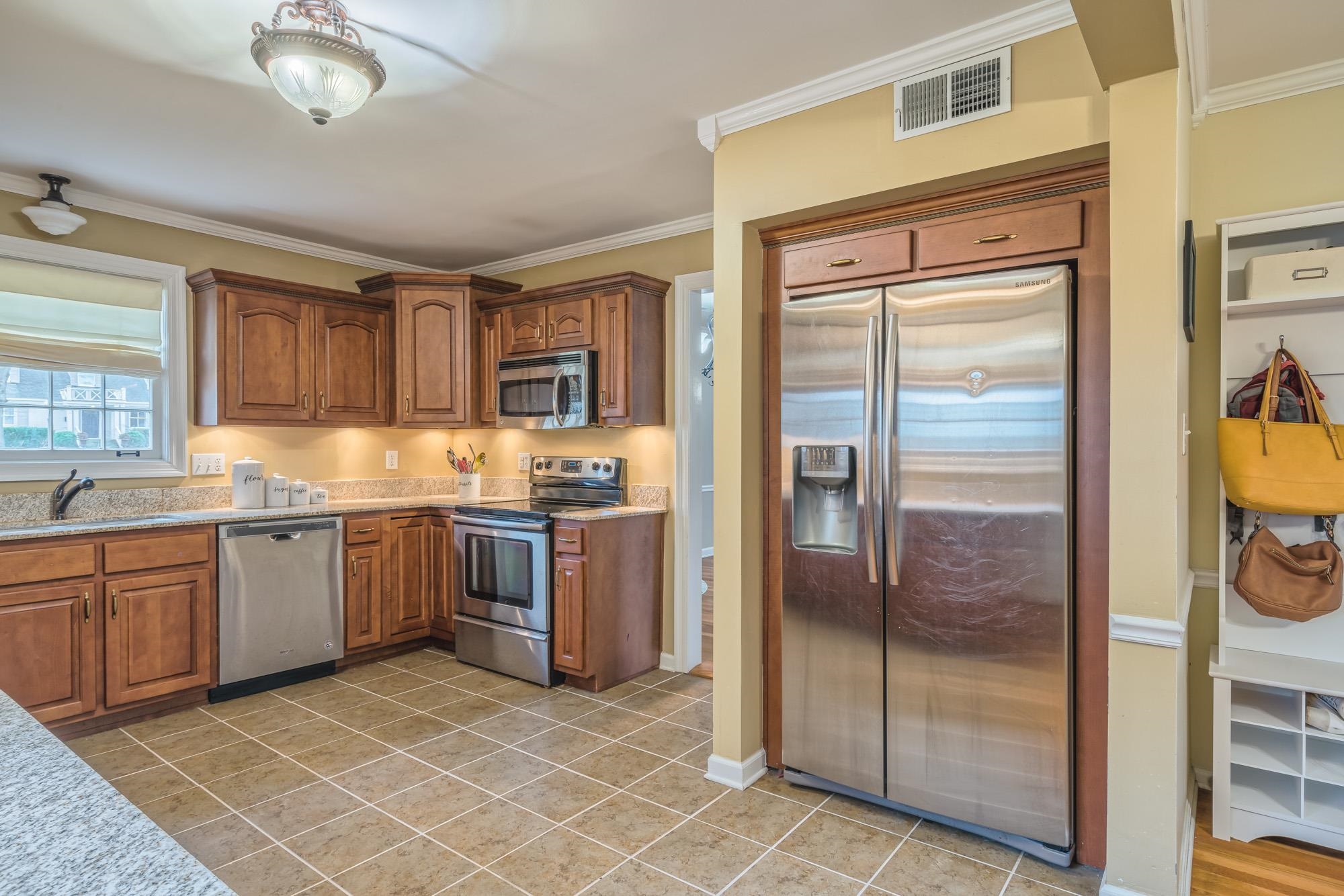 4518 Sequoia Road Memphis, TN 38117 - Photo 8 of 25 a kitchen with a refrigerator a sink and cabinets