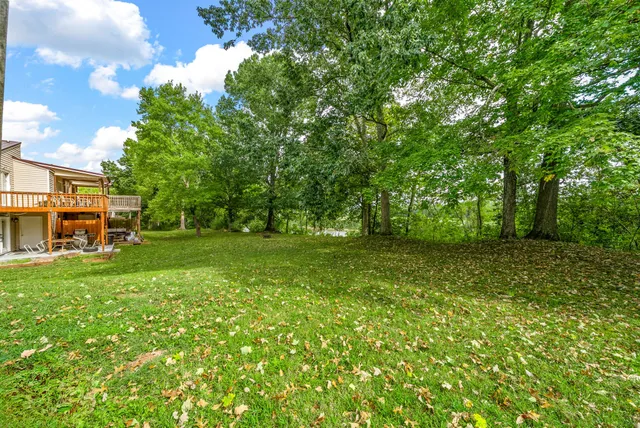 a view of outdoor space with deck and yard
