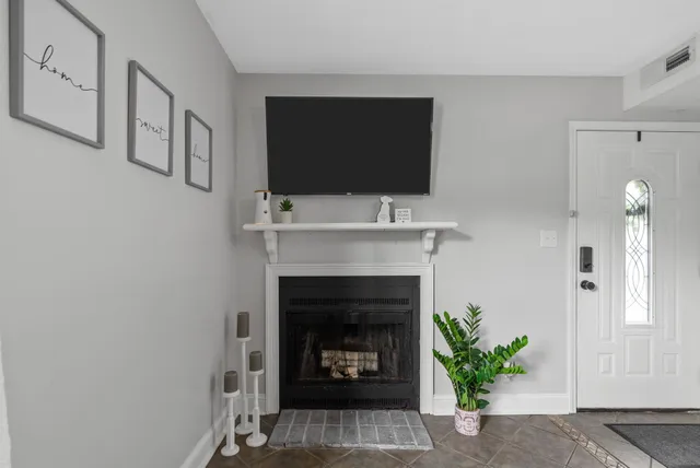 a living room with a fireplace and a flat screen tv