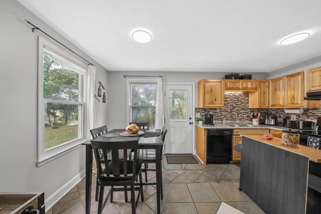 a kitchen with granite countertop lots of counter top space and dining table