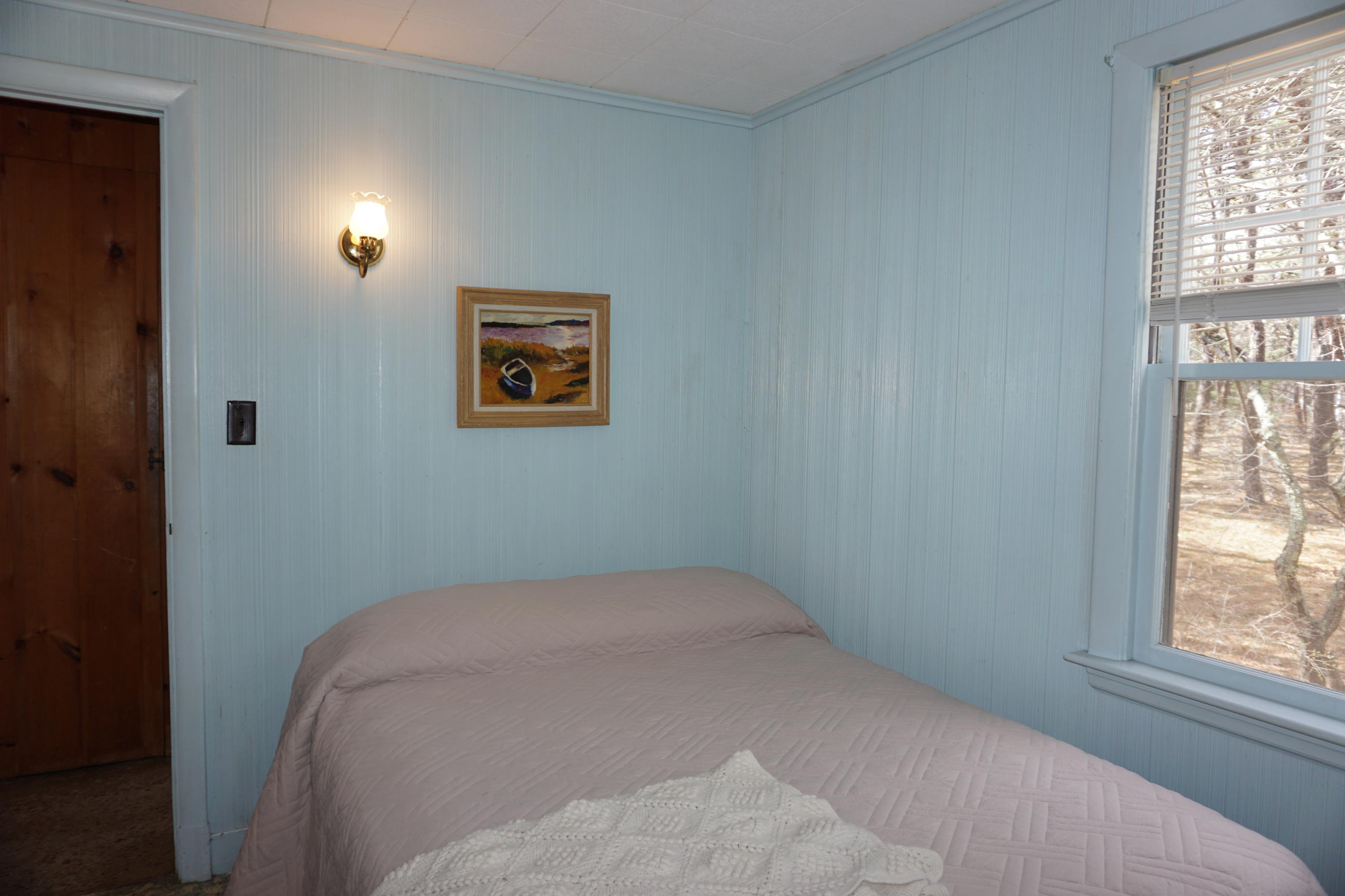 124 Castle Road, Unit 5 Truro, MA 02666 - Photo 11 of 22 a bed room with a bed and a window