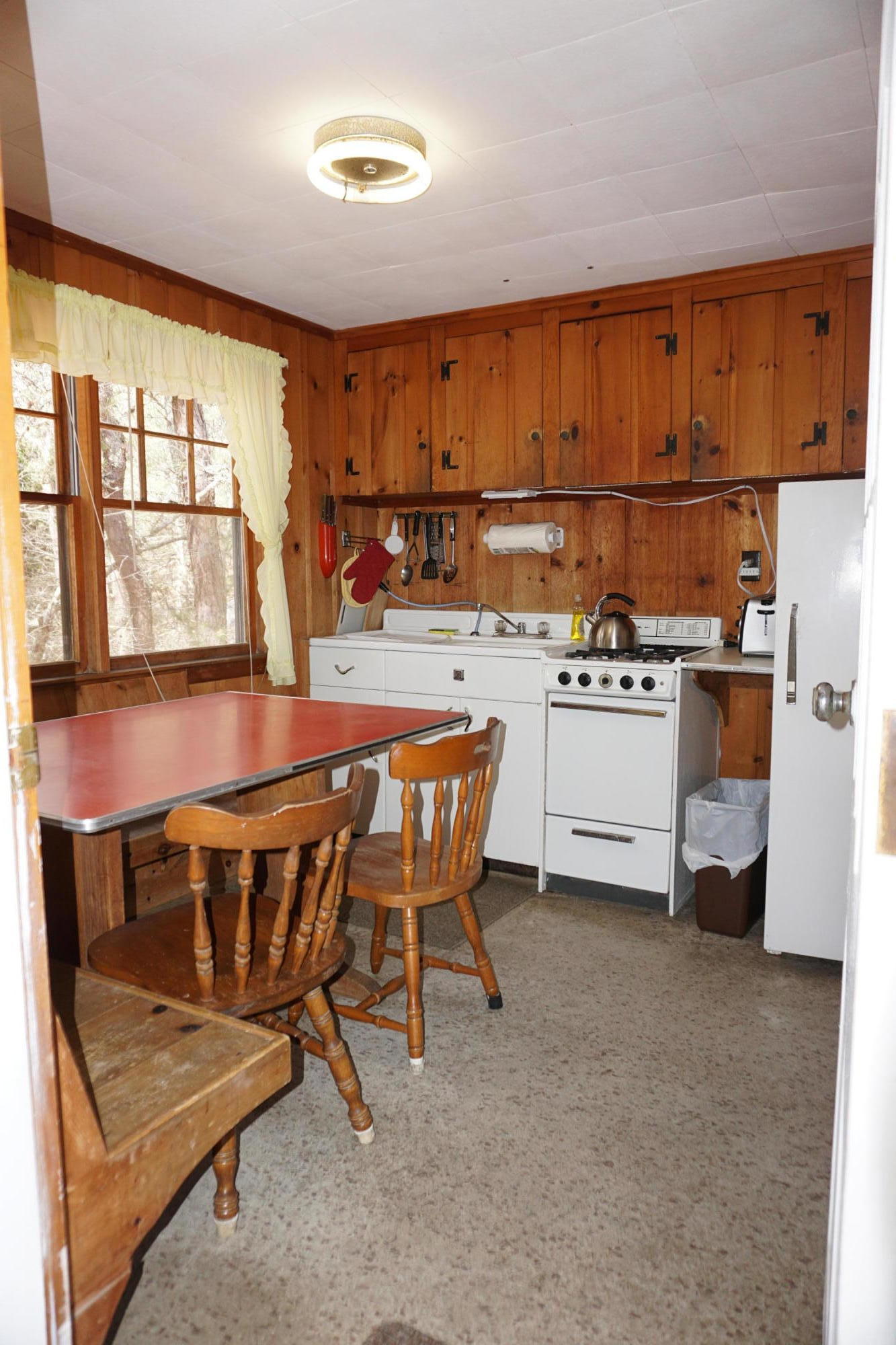 124 Castle Road, Unit 5 Truro, MA 02666 - Photo 8 of 22 a kitchen with a table chairs stove and cabinets