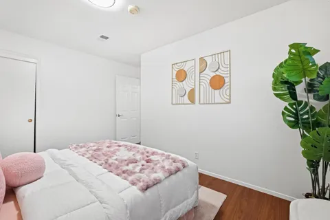 a bedroom with a bed and a potted plant