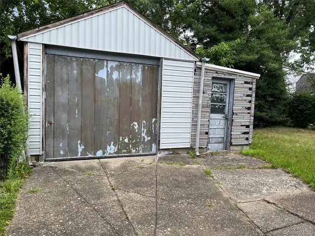 a view of small house with backyard