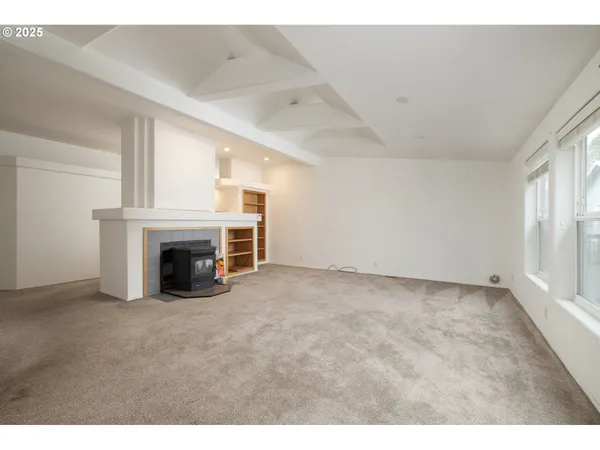 a view of empty room with a fireplace