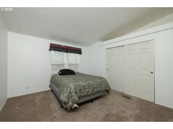 a bedroom with a bed and a window