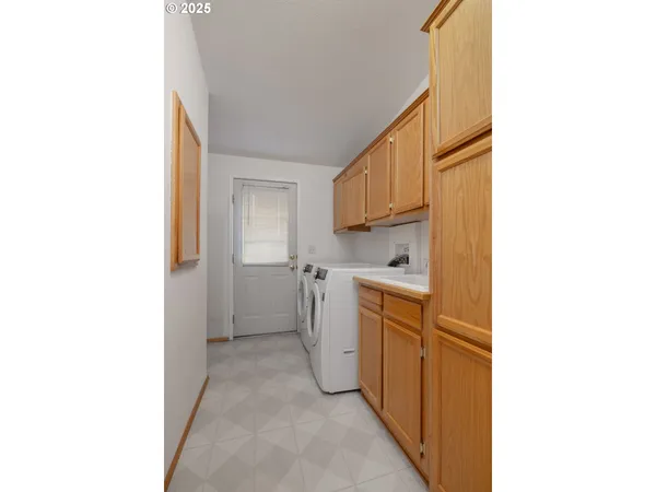 a view of a kitchen with white cabinets