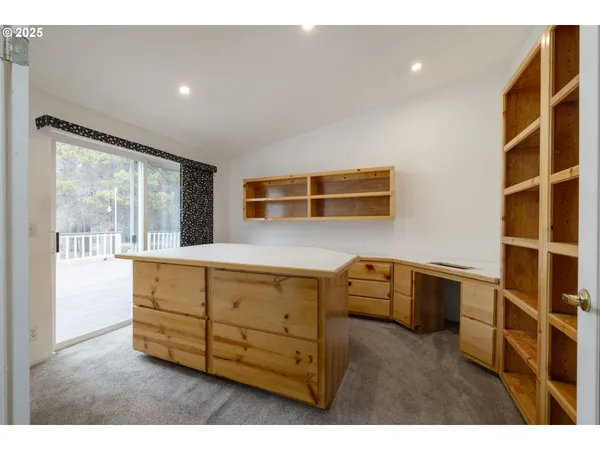a kitchen with stainless steel appliances wooden cabinets and a large window