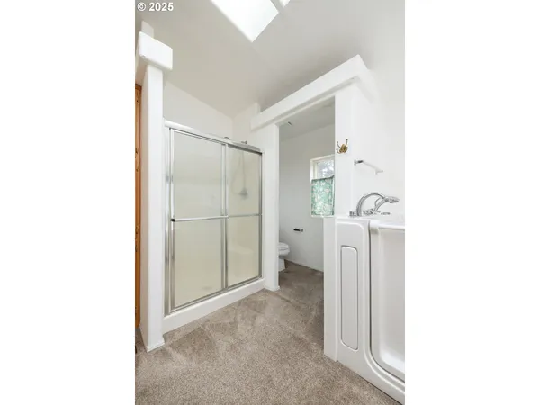 a view of a bathroom with a sink and shower