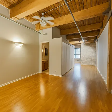 a view of a room with wooden floor