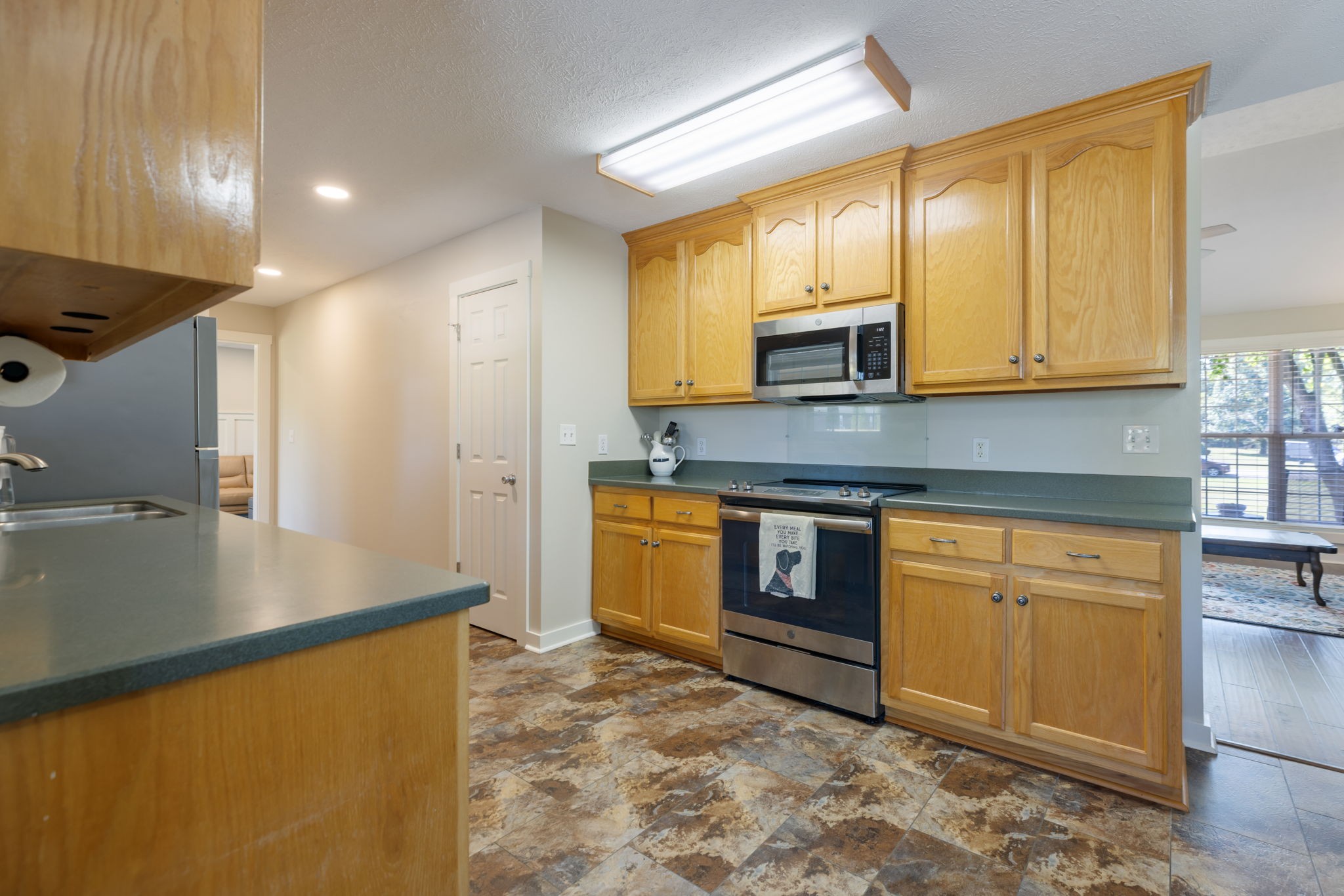 2118 Horton Way Lewisburg, TN 37091 - Photo 29 of 58 a kitchen with stainless steel appliances granite countertop a stove a sink and a microwave