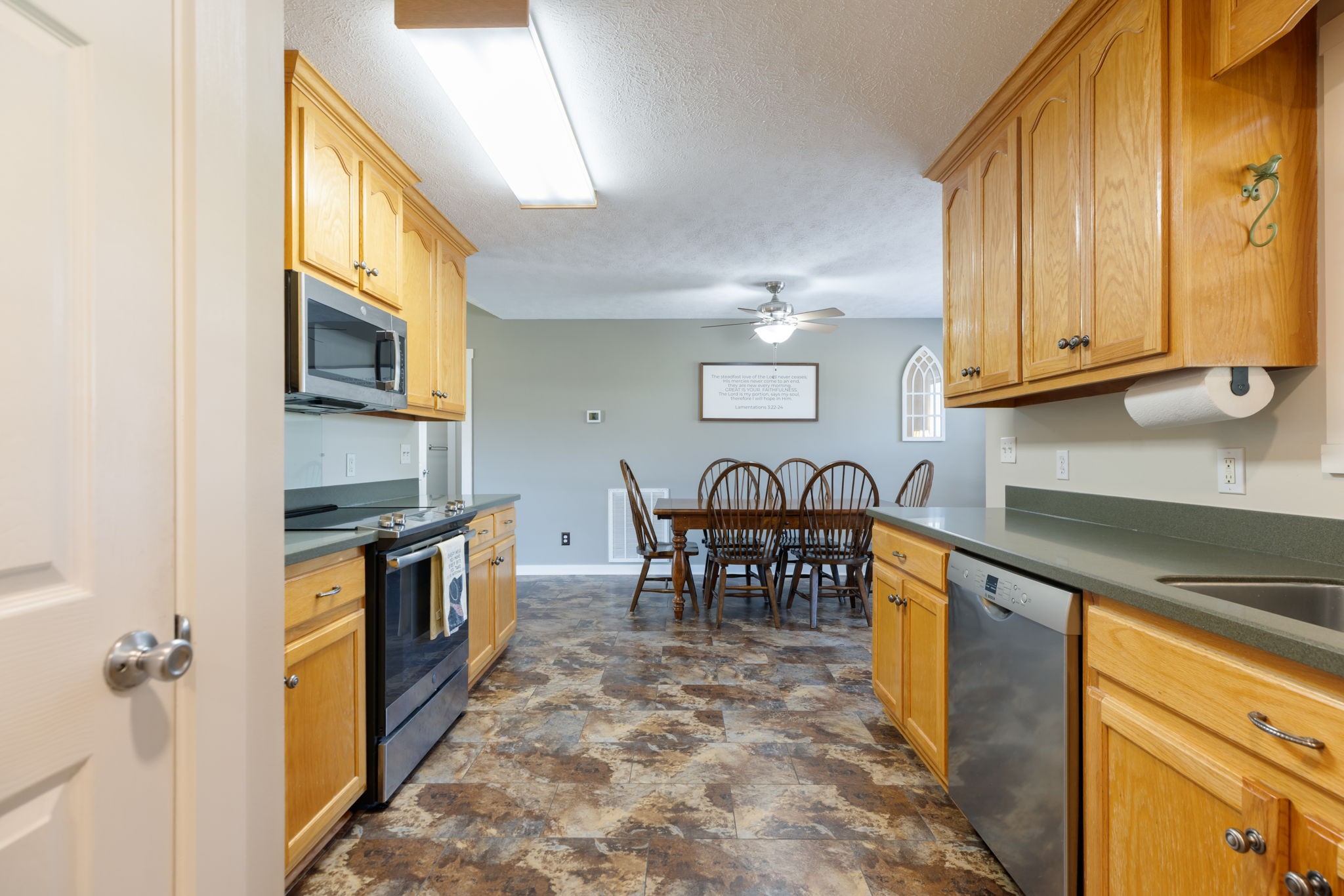 2118 Horton Way Lewisburg, TN 37091 - Photo 33 of 58 a kitchen with granite countertop a stove a sink and a microwave