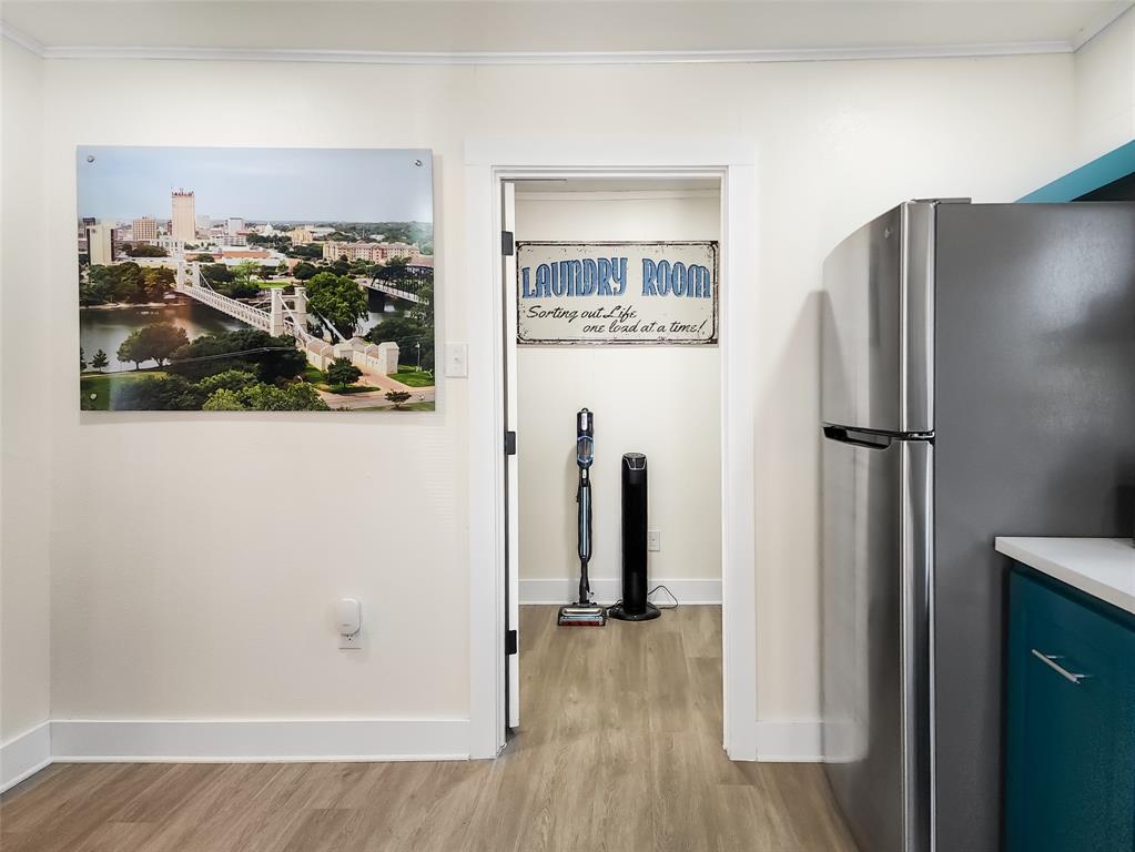 2800 McKenzie Avenue Waco, TX 76708 - Photo 22 of 40 a view of a hallway with wooden floor and a cabinet