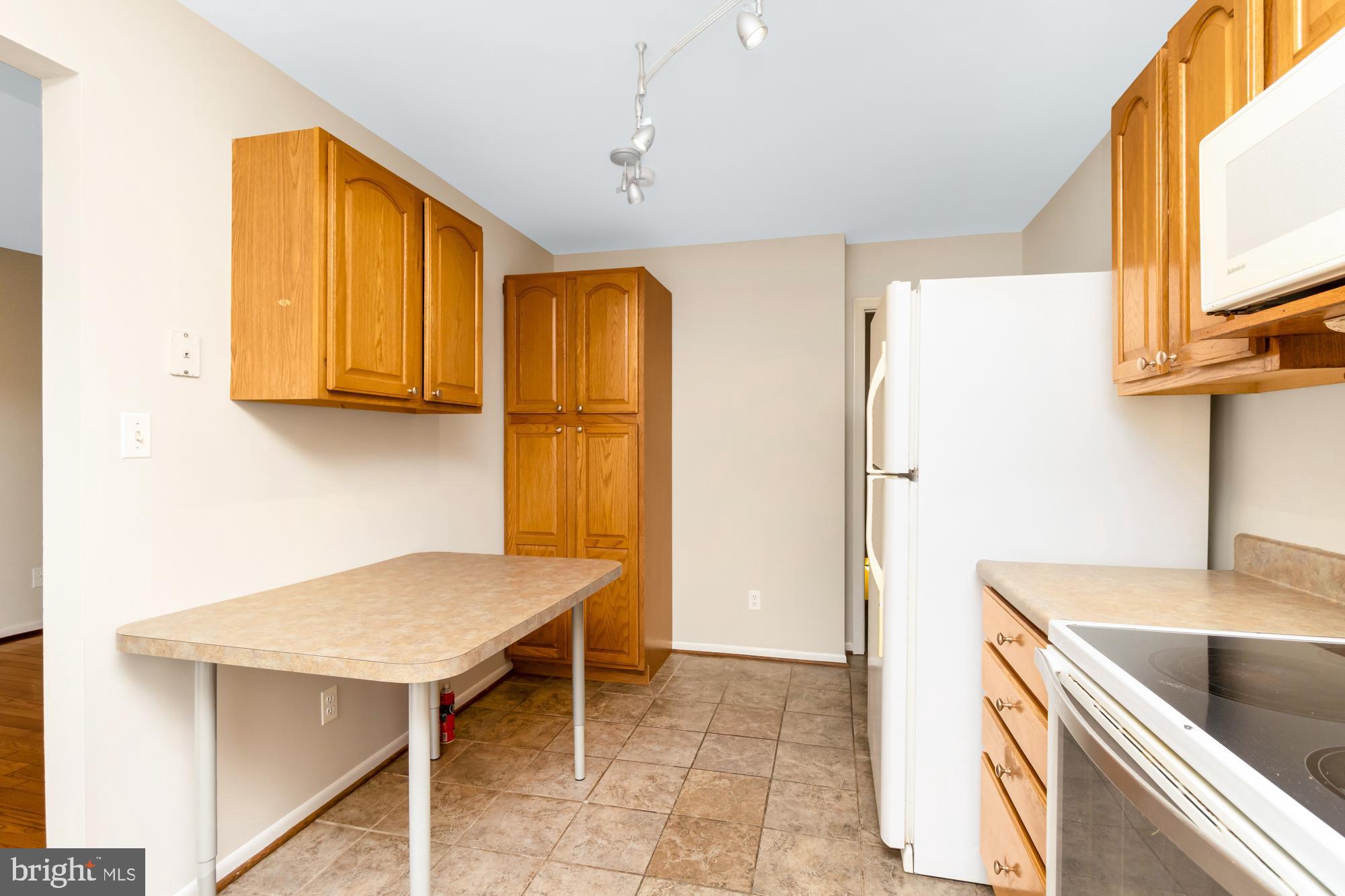 3640 Rockberry Road Baltimore, MD 21234 - Photo 11 of 37 a kitchen with a sink a stove and a refrigerator