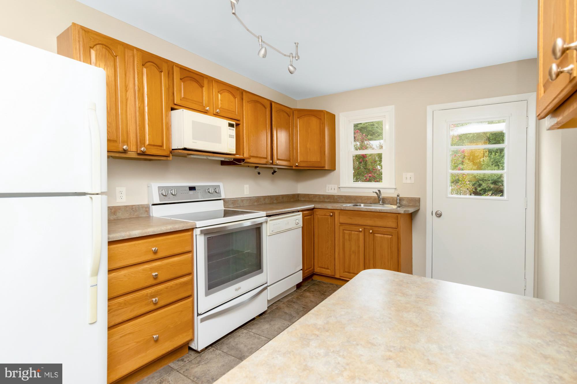 3640 Rockberry Road Baltimore, MD 21234 - Photo 12 of 37 a kitchen with stainless steel appliances granite countertop a stove a sink and a refrigerator