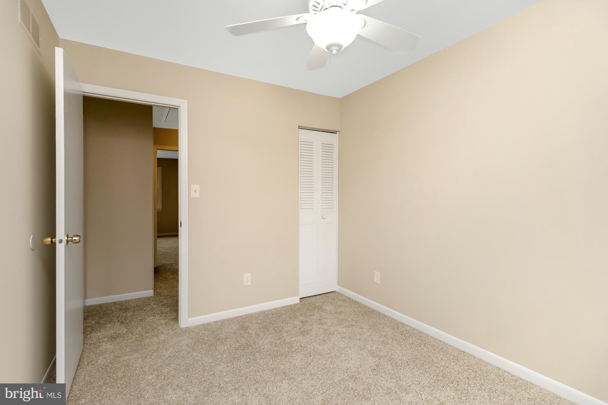 3640 Rockberry Road Baltimore, MD 21234 - Photo 23 of 37 an empty room with a chandelier fan