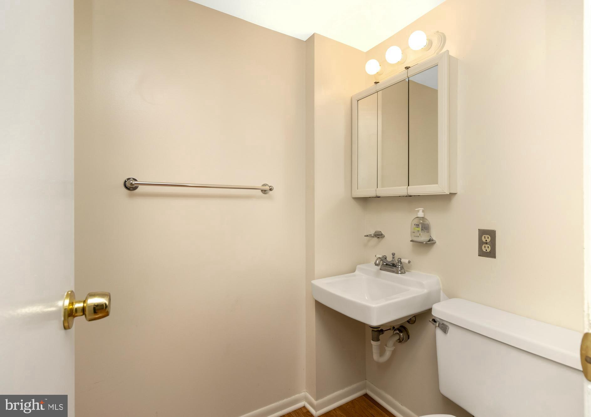 3640 Rockberry Road Baltimore, MD 21234 - Photo 29 of 37 a bathroom with a sink a toilet and mirror