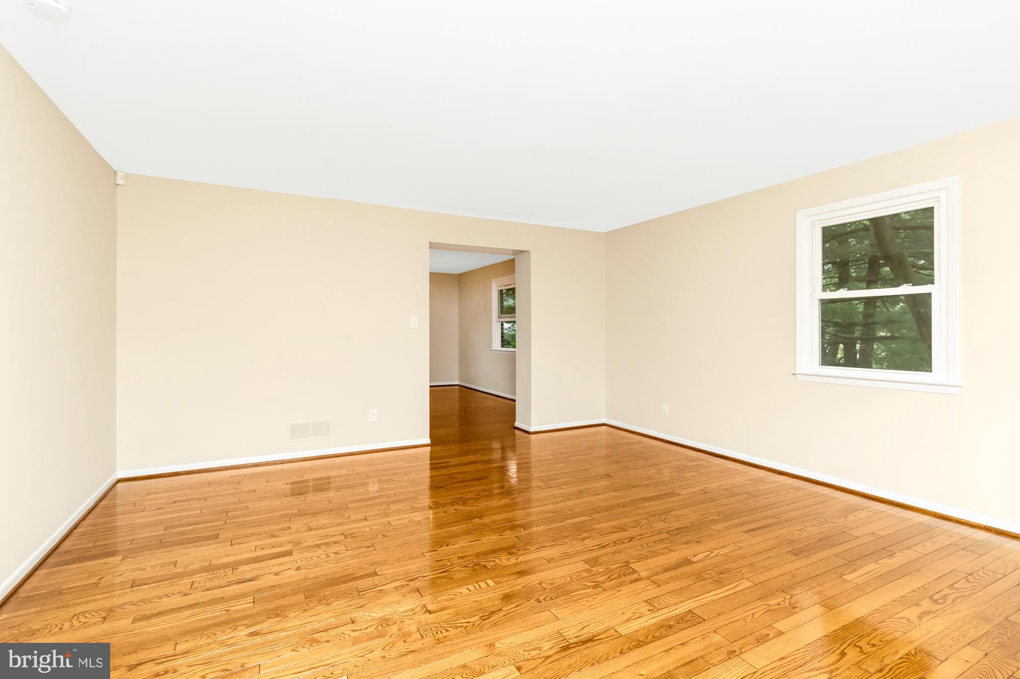 3640 Rockberry Road Baltimore, MD 21234 - Photo 5 of 37 a view of an empty room with wooden floor and a window