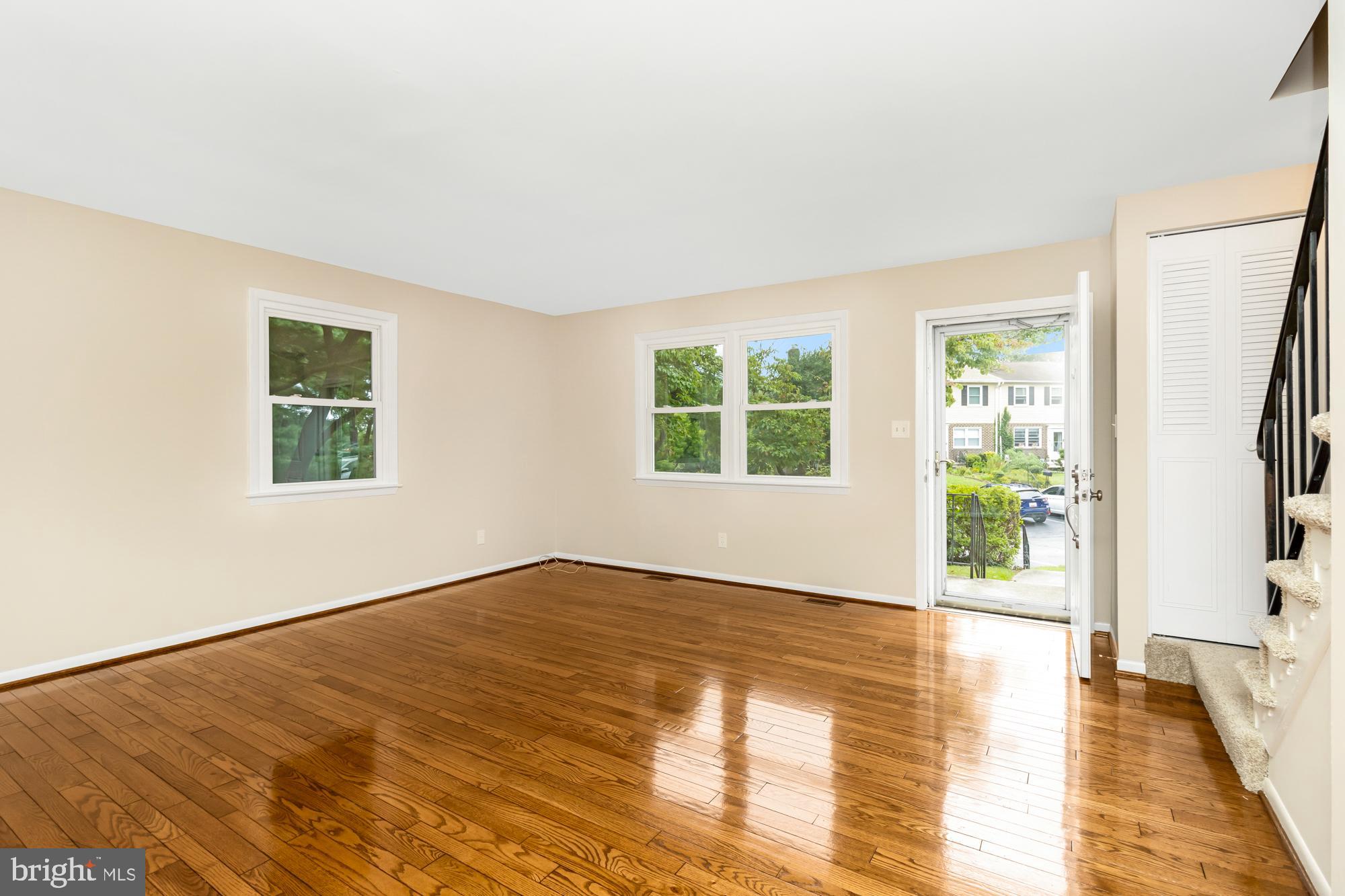 3640 Rockberry Road Baltimore, MD 21234 - Photo 6 of 37 a view of an empty room with a window and wooden floor