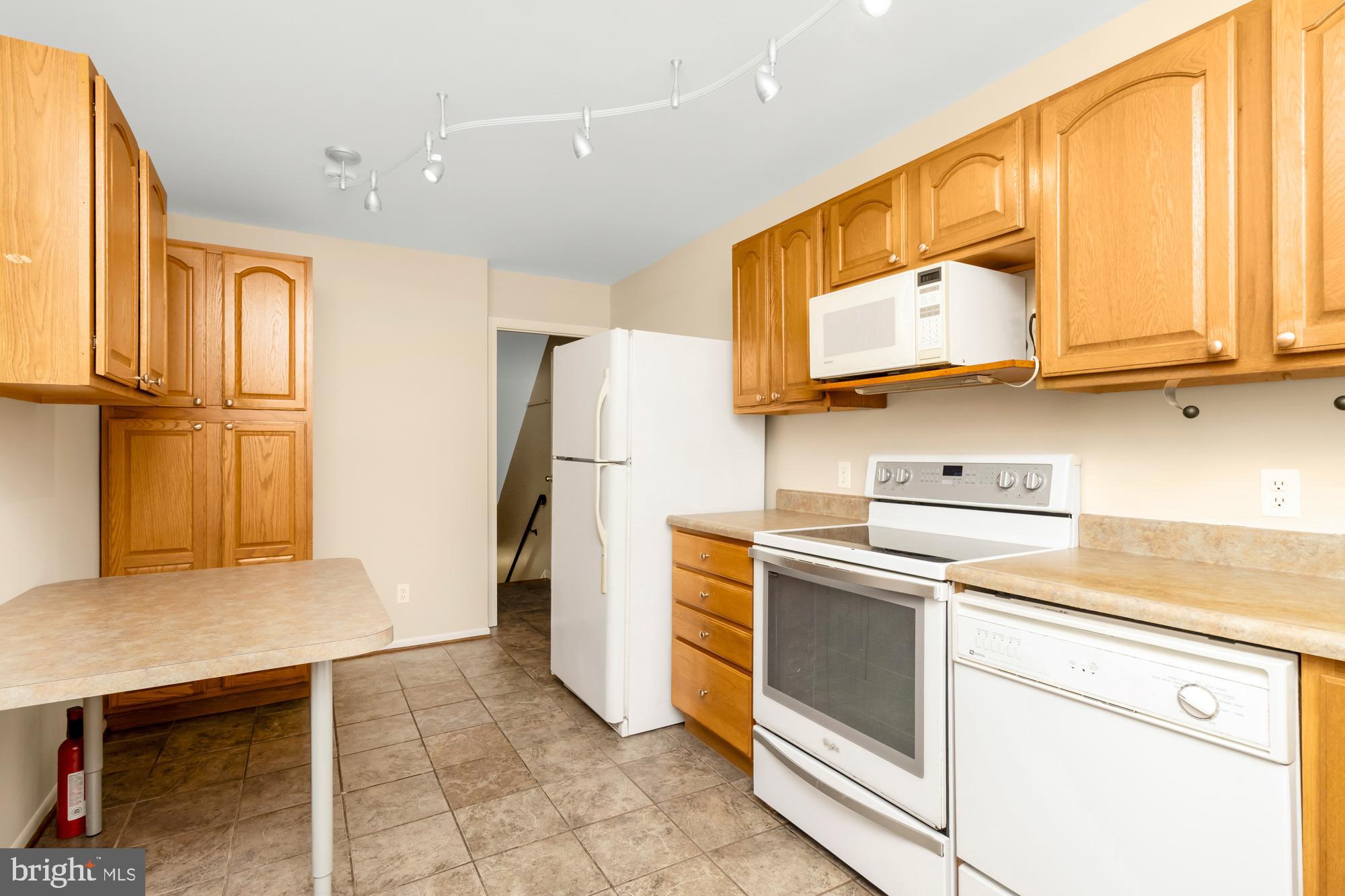 3640 Rockberry Road Baltimore, MD 21234 - Photo 10 of 37 a kitchen with a refrigerator sink and cabinets