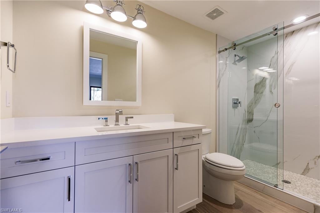 1300 Dolphin Road Naples, FL 34102 - Photo 13 of 22 a bathroom with a sink toilet and shower