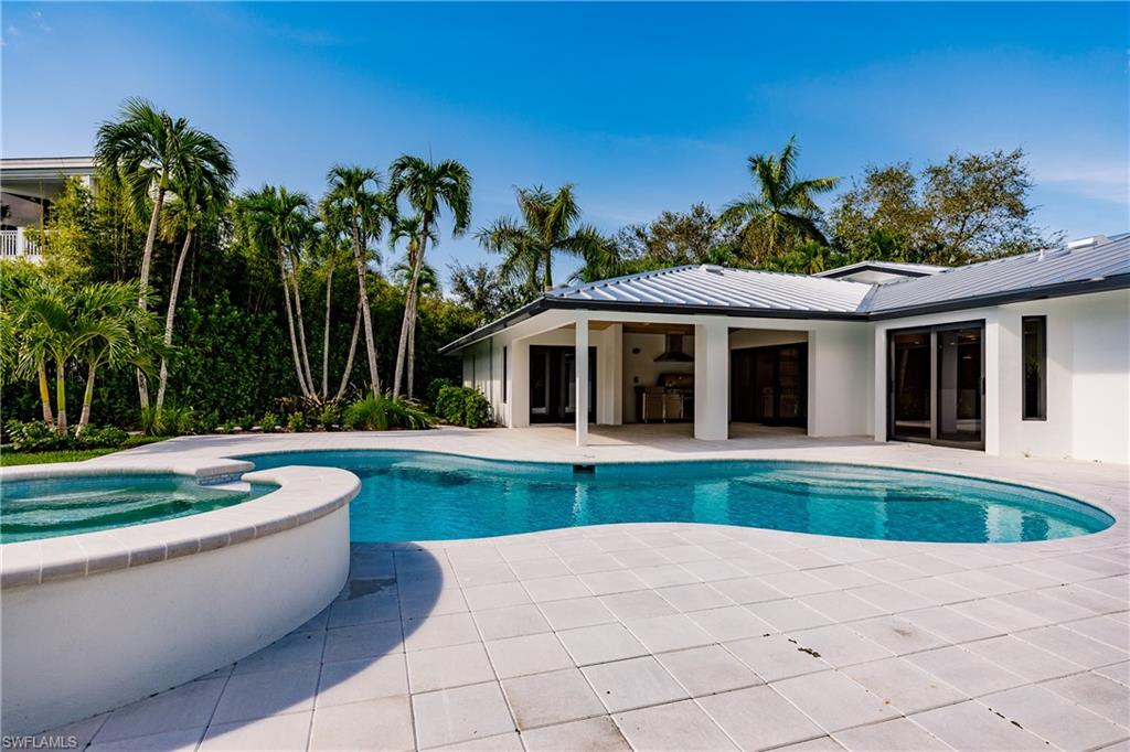 1300 Dolphin Road Naples, FL 34102 - Photo 17 of 22 a front view of house with yard swimming pool and outdoor seating