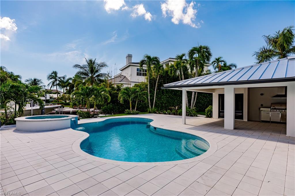 1300 Dolphin Road Naples, FL 34102 - Photo 18 of 22 a view of a house with swimming pool and sitting area
