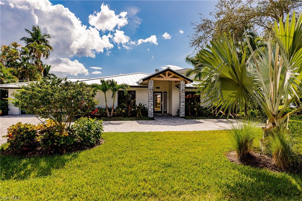 1300 Dolphin Road Naples, FL 34102 - Photo 2 of 22 a view of a house with swimming pool and a yard