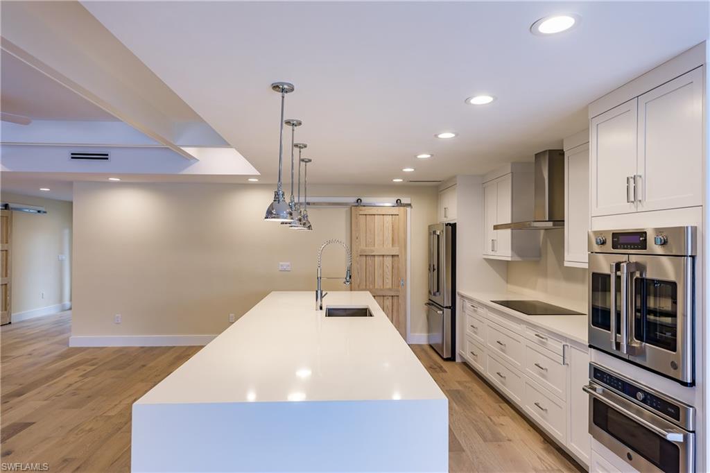 1300 Dolphin Road Naples, FL 34102 - Photo 4 of 22 a large kitchen with a large counter top appliances and cabinets