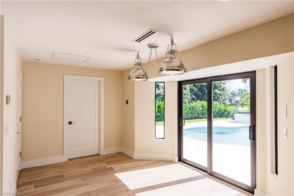 1300 Dolphin Road Naples, FL 34102 - Photo 6 of 22 a view of a livingroom with a chandelier fan and windows