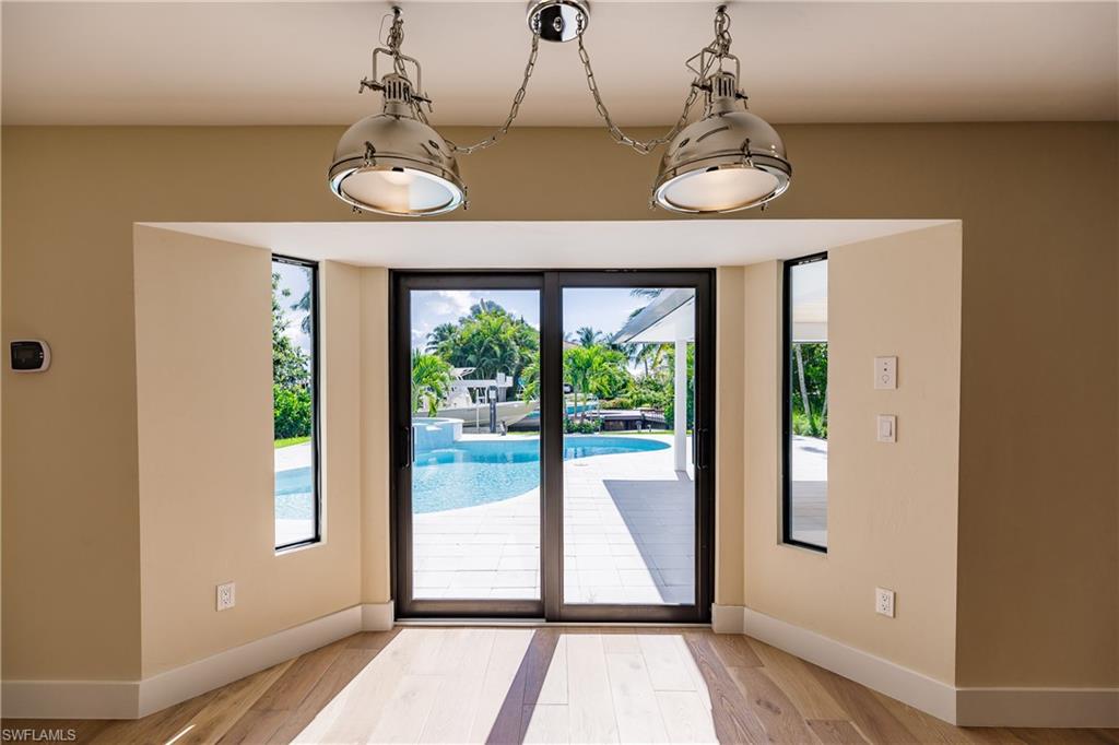 1300 Dolphin Road Naples, FL 34102 - Photo 7 of 22 a view of a room with wooden floor and windows