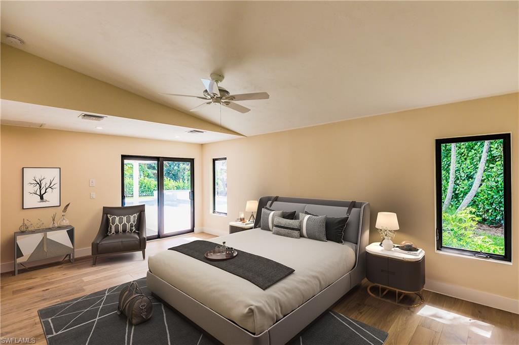 1300 Dolphin Road Naples, FL 34102 - Photo 8 of 22 a bedroom with a bed and wooden floor