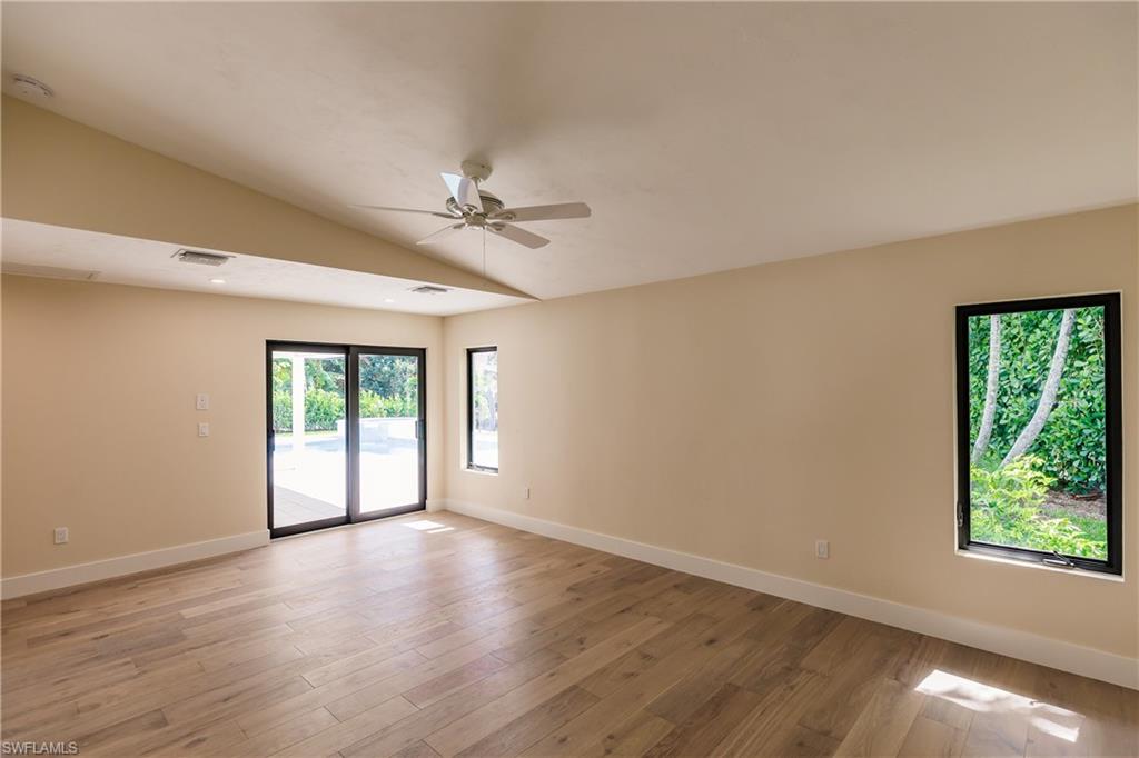 1300 Dolphin Road Naples, FL 34102 - Photo 9 of 22 a view of an empty room with a window and wooden floor