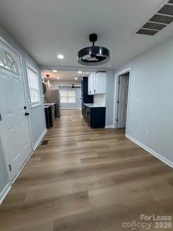 a view of kitchen with sink microwave and refrigerator