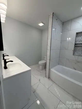 a bathroom with a sink a toilet and bathtub