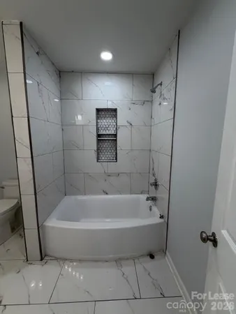 a bathroom with a tub and shower