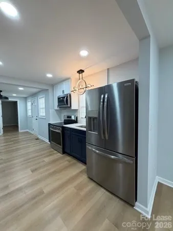 a kitchen with stainless steel appliances granite countertop a refrigerator sink and cabinets