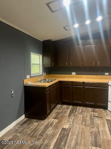 a kitchen with a sink and a stove top oven