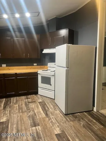 a white refrigerator freezer sitting inside of a kitchen