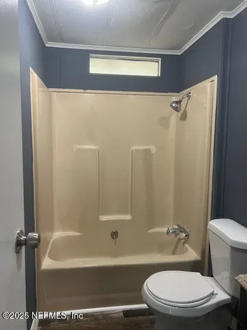 a bathroom with a toilet and a bathtub