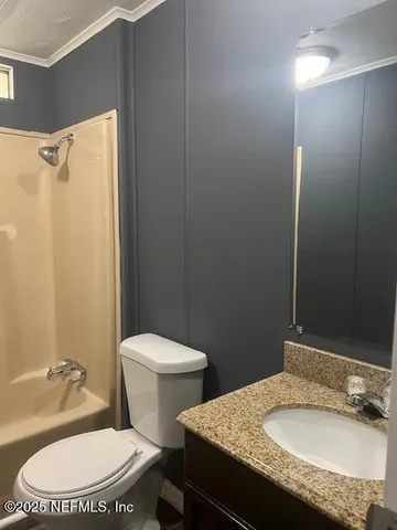 a white toilet sitting next to a bathroom sink