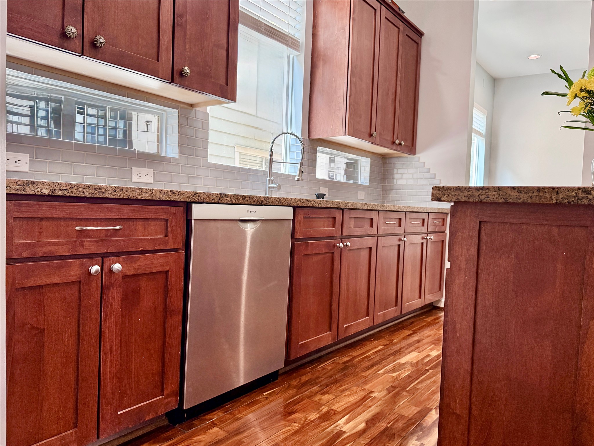 608 West Drew Street, Unit B Houston, TX 77006 - Photo 18 of 42 a kitchen with granite countertop wooden cabinets a sink and dishwasher
