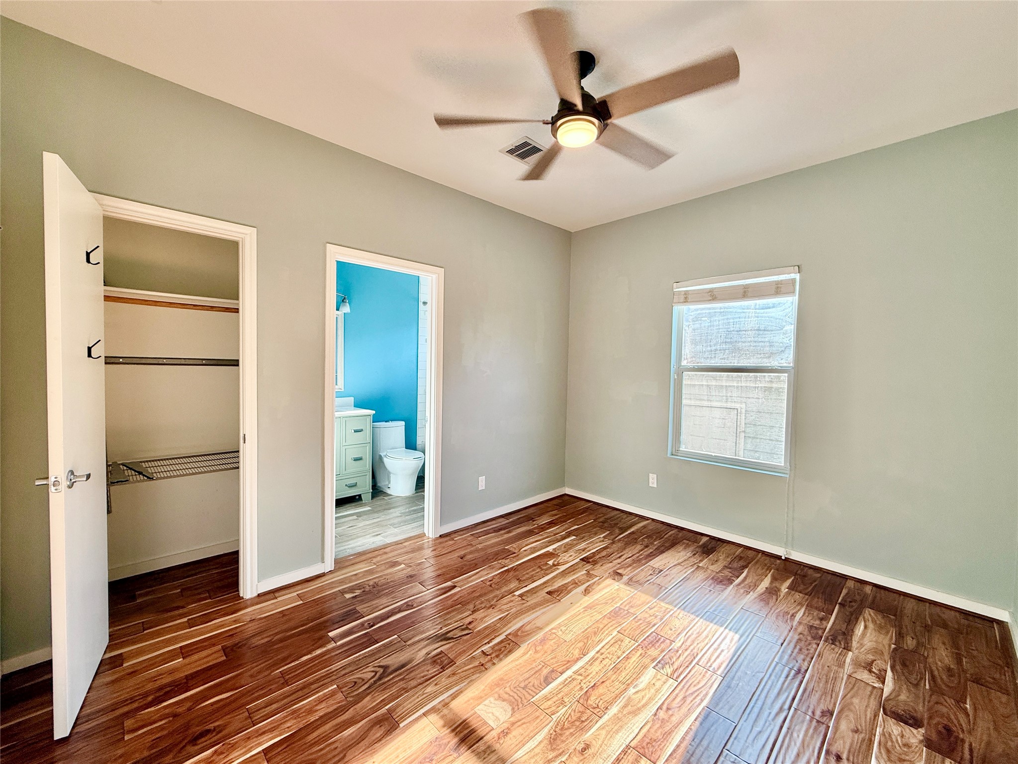 608 West Drew Street, Unit B Houston, TX 77006 - Photo 25 of 42 a view of an empty room with wooden floor and a window