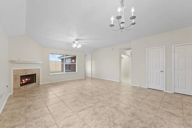 a view of livingroom chandelier fan and fireplace