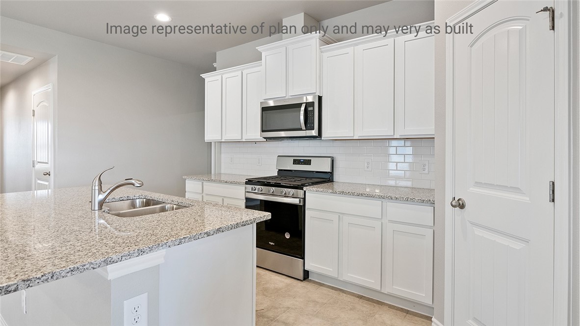 1411 Choctaw Road Sinton, TX 78387 - Photo 9 of 28 a kitchen with granite countertop cabinets stainless steel appliances and a sink