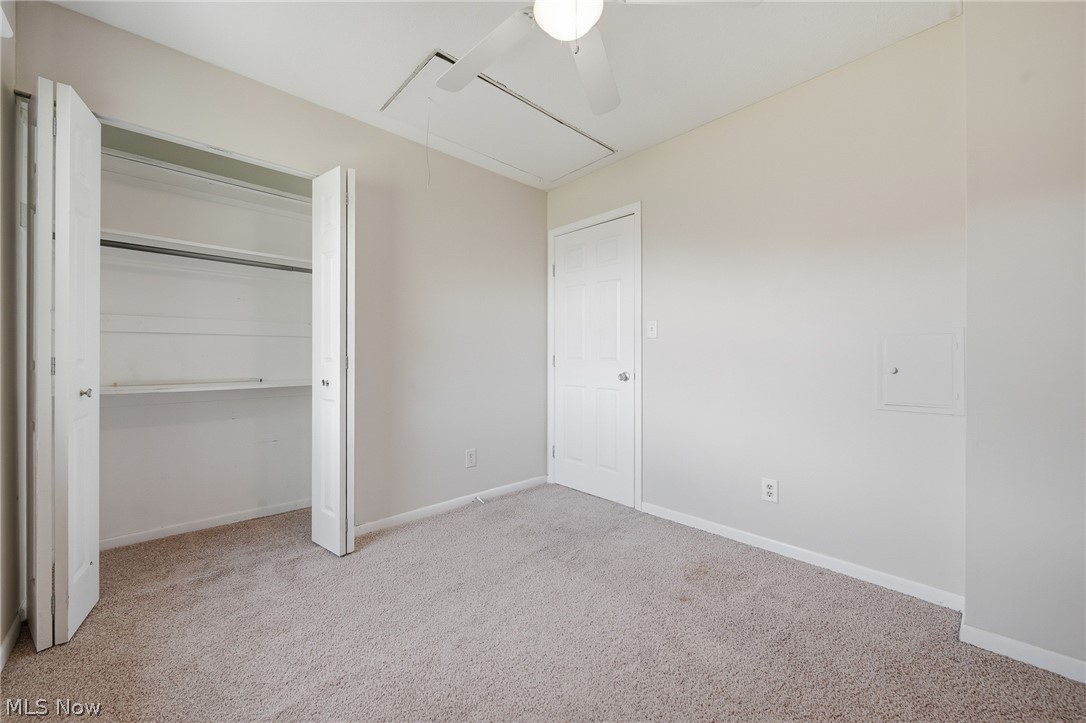 824 South Chillicothe Road, Unit 2 Aurora, OH 44202 - Photo 18 of 42 Interior room featuring wall-to-wall carpeting, light neutral wall paint, and a white ceiling fan
