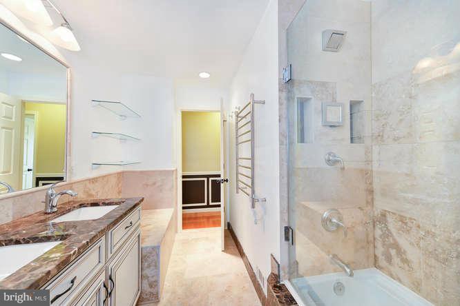 5918 Atteentee Road Springfield, VA 22150 - Photo 15 of 25 a spacious bathroom with a granite countertop sink mirror and shower