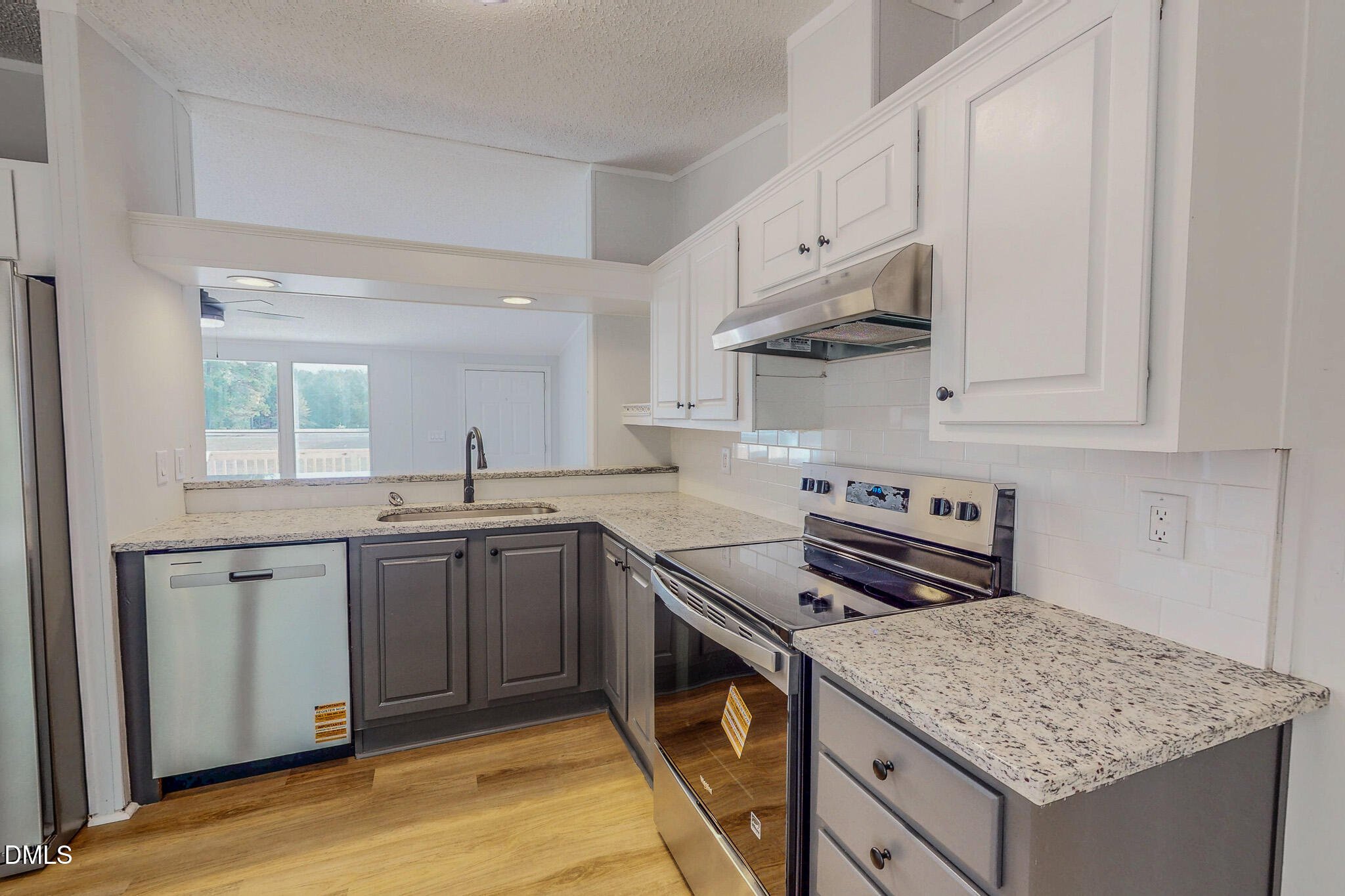 1469 Mollie Mooney Road Roxboro, NC 27574 - Photo 14 of 52 a kitchen with stainless steel appliances granite countertop a stove and a sink