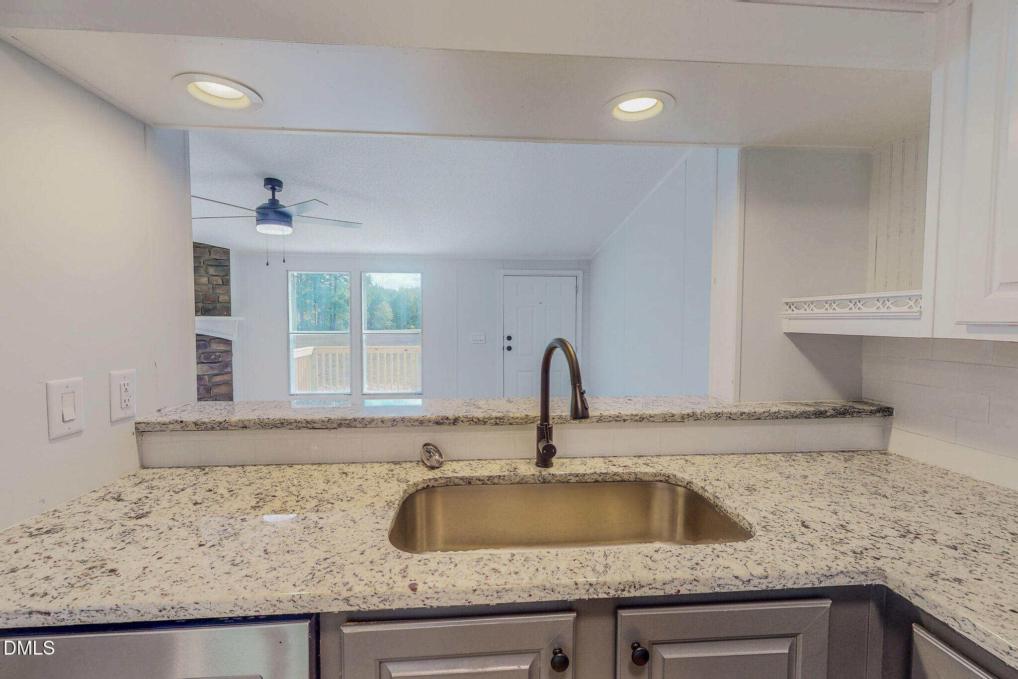1469 Mollie Mooney Road Roxboro, NC 27574 - Photo 15 of 52 a kitchen with granite countertop a sink and a granite counter tops